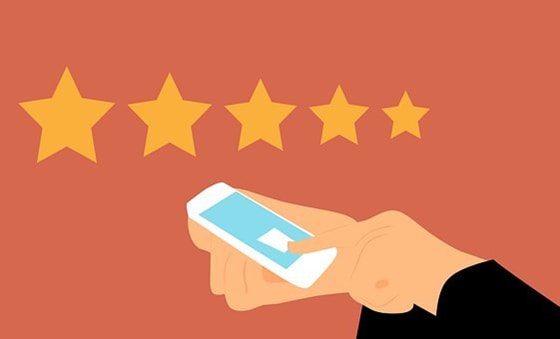 cartoon of a hand holding a mobile phone and giving five star rating