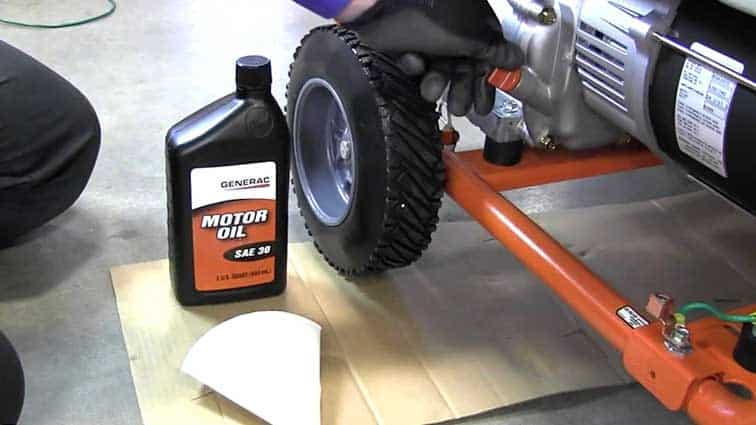 Bottle of motor Oil next to a portable generator