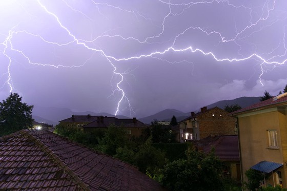 a view of lightning from the top of houses